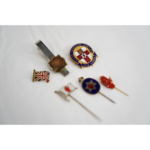 331 - A collection of 6 tie pins & badges.