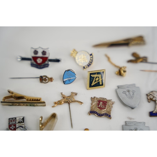 332 - A large collection of vintage badges etc.