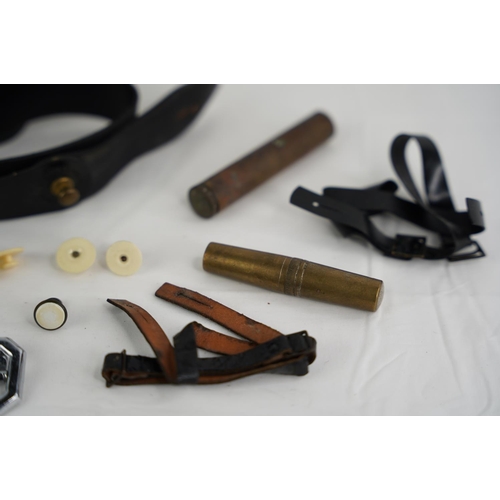 340 - An assortment of items to include a vintage RUC/ RIC belt, brass cased rifle oiler & brass cased too... 