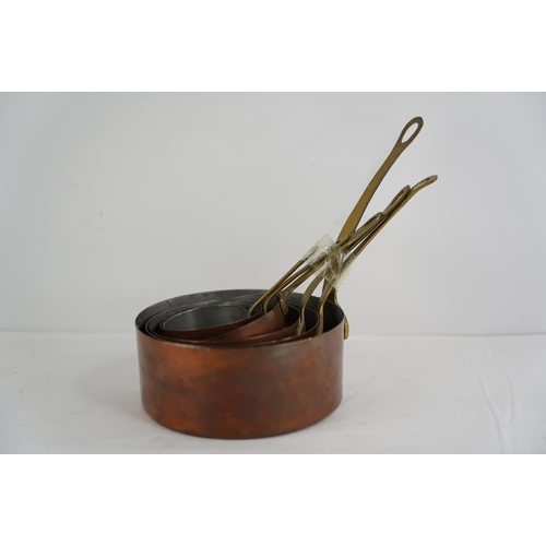 365 - A set of 6 antique graduating copper saucepans with brass handles.