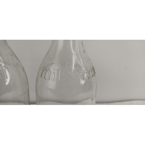 373 - A collection of vintage glass milk bottles.