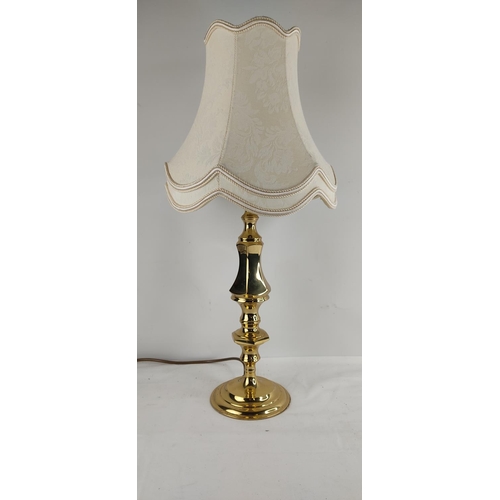 388 - A vintage brass based table lamp with shade.