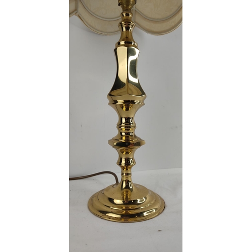 388 - A vintage brass based table lamp with shade.