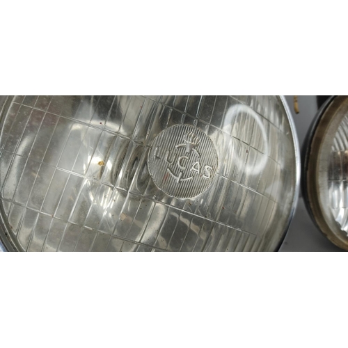 395 - An assortment of various classic car spares to include lights, a horn & more.