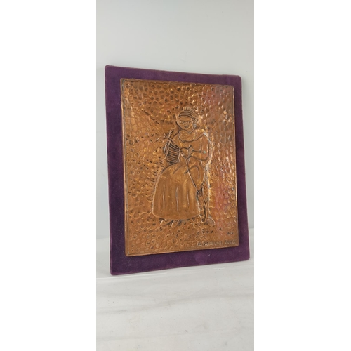 428 - A handmade copper plaque of a knitting woman.