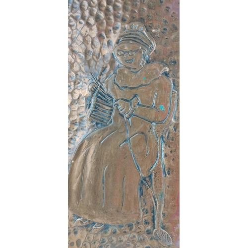 428 - A handmade copper plaque of a knitting woman.