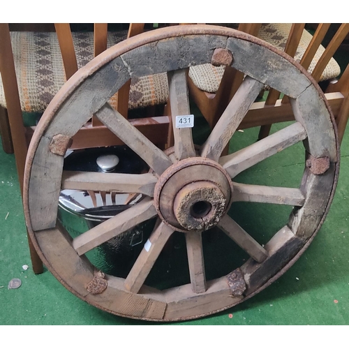 431 - A large antique wooden cart wheel.