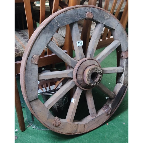 431 - A large antique wooden cart wheel.