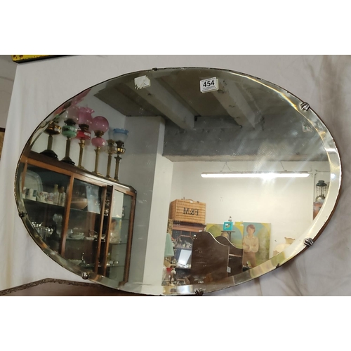 454 - A vintage Art Deco frameless bevelled glass mirror.