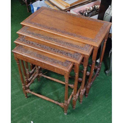 460 - A stunning nest of 4 antique tables with decoratively carved boarder design to each top.