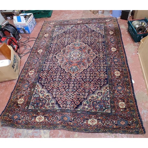 423 - A large decorative rug, measuring 85