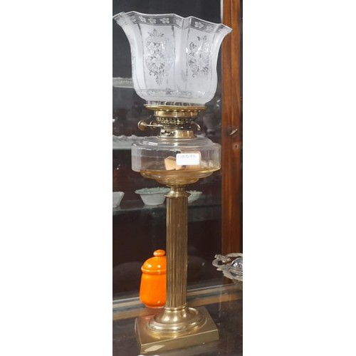 157 - An antique Corinthian clear glass font oil lamp with etched glass shade.