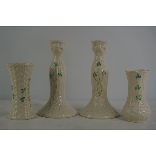 118 - A pair of Belleek pottery candlesticks and two vases.