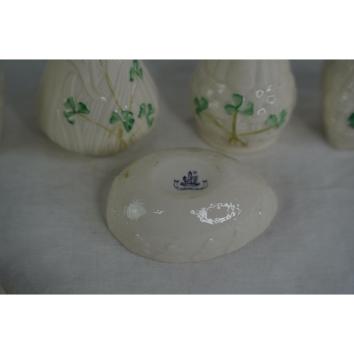 119 - Four Belleek pottery vases and a lidded egg shaped trinket holder.