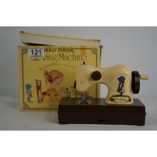 121 - A vintage boxed Holly Hobbie toy sewing machine.