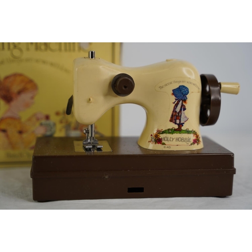 121 - A vintage boxed Holly Hobbie toy sewing machine.