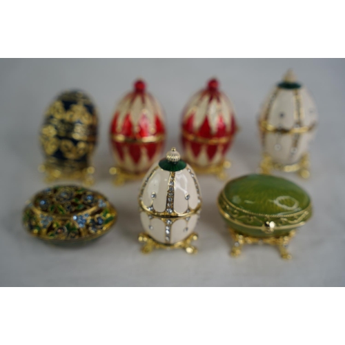 123 - A collection of egg shaped trinket boxes.