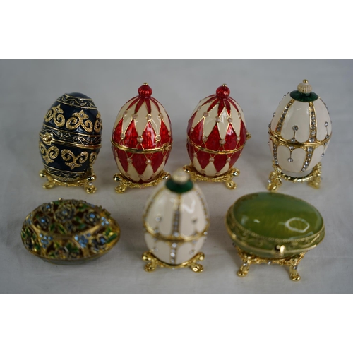 123 - A collection of egg shaped trinket boxes.