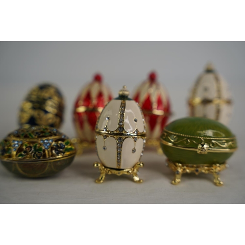 123 - A collection of egg shaped trinket boxes.