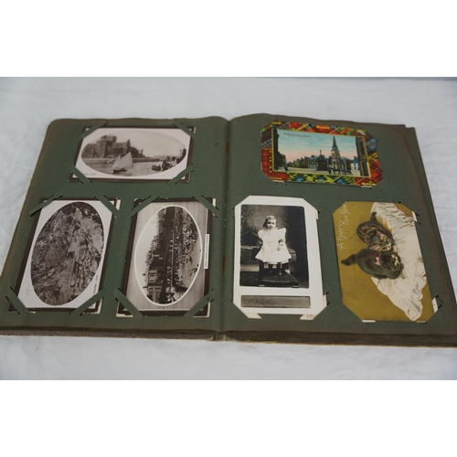 26 - An antique postcard album.