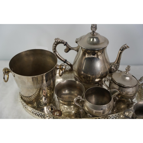 32 - An EPNS tea service and tray, a silver plated ice bucket and more.