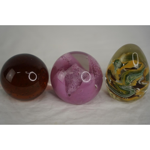 34 - Three vintage glass paperweights.