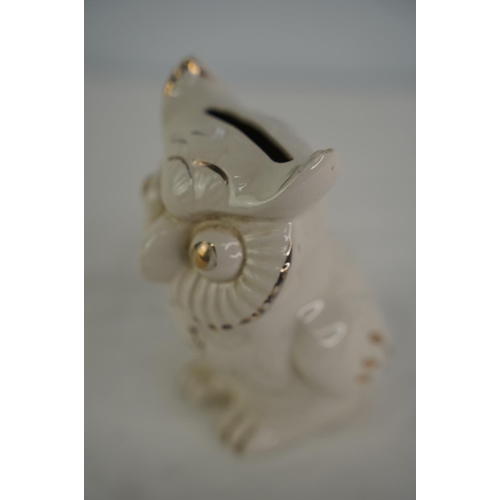 42 - An antique ceramic owl money box.