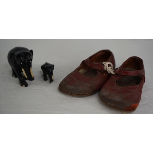 48 - A pair of vintage child's leather shoes and two ornamental elephants.