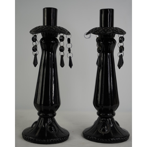 49 - A pair of coloured glass candlesticks.