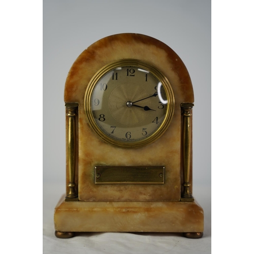 60 - An antique French marble and brass mantle clock with presentation plaque.