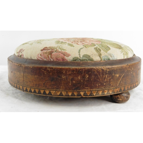 173 - An antique mahogany circular footstool with inlay detail.