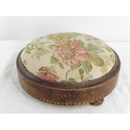 173 - An antique mahogany circular footstool with inlay detail.