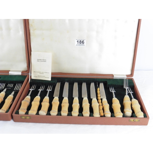 186 - Two vintage cased sets of Mills Moore stainless steel cutlery with walnut wood handles.