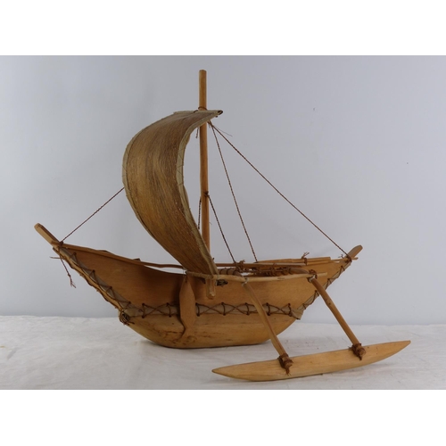 202 - A vintage Polynesian style hand crafted fishing boat.