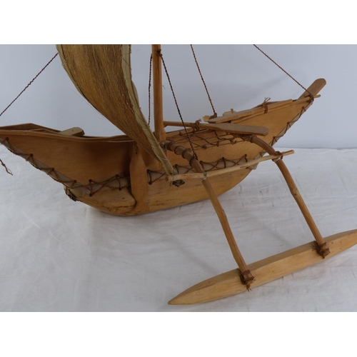 202 - A vintage Polynesian style hand crafted fishing boat.