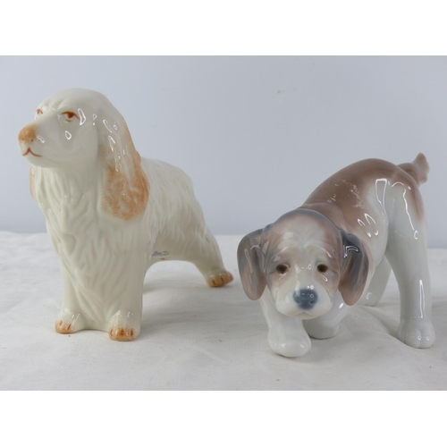 204 - A pair of Royal Doulton dog and cat figures and a Lladro dog.