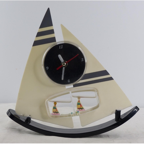 211 - A vintage table top desk clock with water and rocking feature.