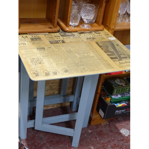 212 - A small upcycled dropleaf table with decoupage newspaper top.