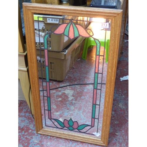 213 - A decorative wall mirror.