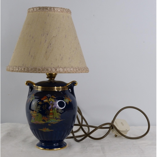 234 - A vintage hand painted Crown Devon table lamp and shade.