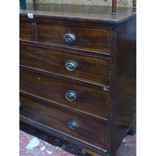 243 - A mahogany and inlay chest of five drawers.