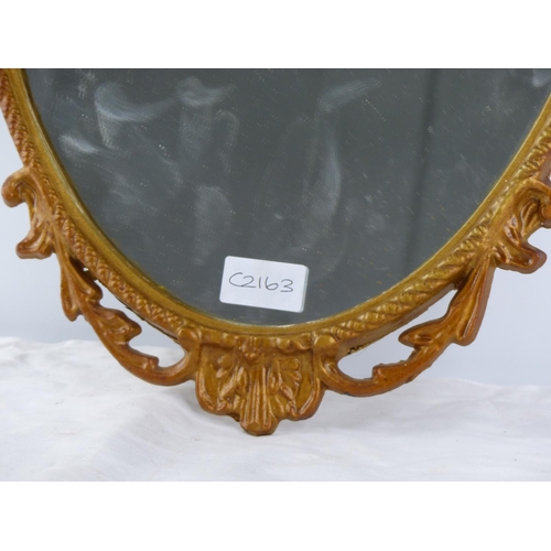 268 - An antique metal framed wall mirror 65cm .