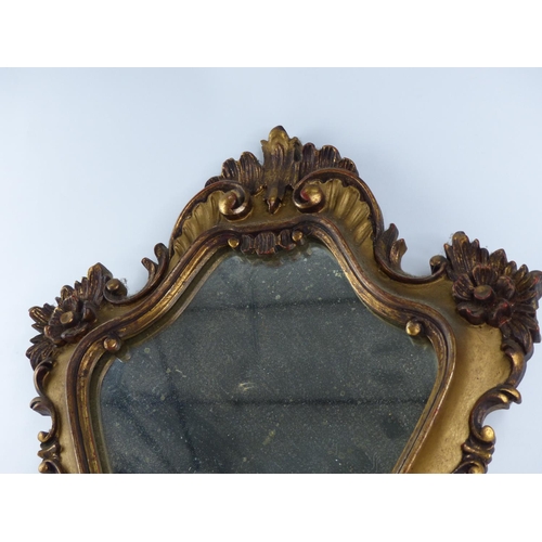 318 - A decorative gilt wall mirror.