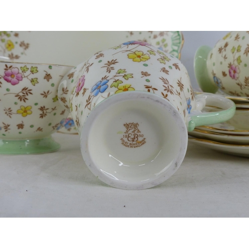 355 - A vintage rattan shopping basket and 21 piece Ripley bone china tea set.