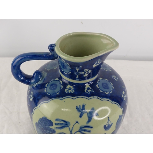 388 - A Japanese/ Chinese blue and white patterned jug.