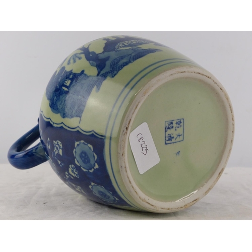 388 - A Japanese/ Chinese blue and white patterned jug.