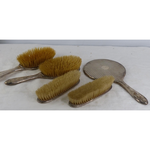 492 - A set of Sterling silver backed dressing table brushes and mirror.