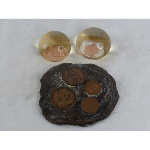 496 - A coin inset wall plaque and two resin coin paperweights.