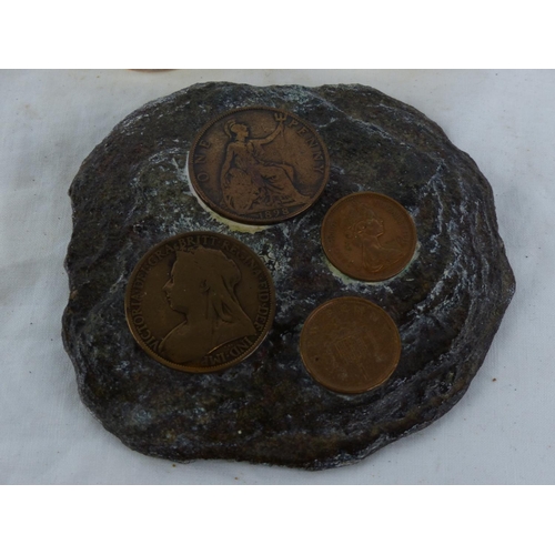 496 - A coin inset wall plaque and two resin coin paperweights.