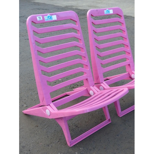 10 - A pair of folding plastic chairs.